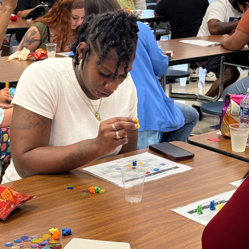 A mother playing an interactive family engagement game at a Second Mile Parent Party